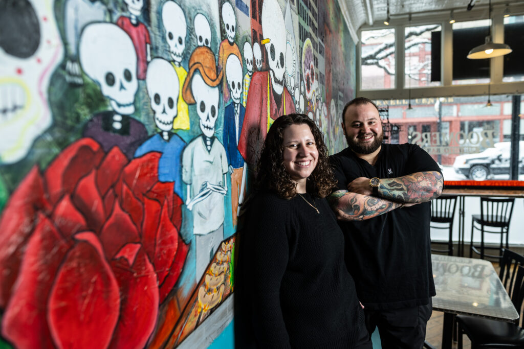 Nicole and Andrew Standing by Mural